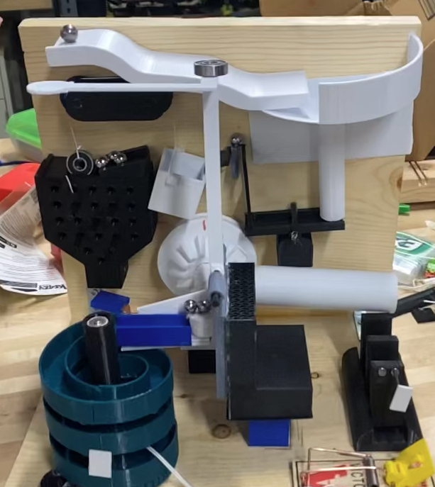 Mechanism layout and staging focused on reliable handoffs and manufacturable parts.