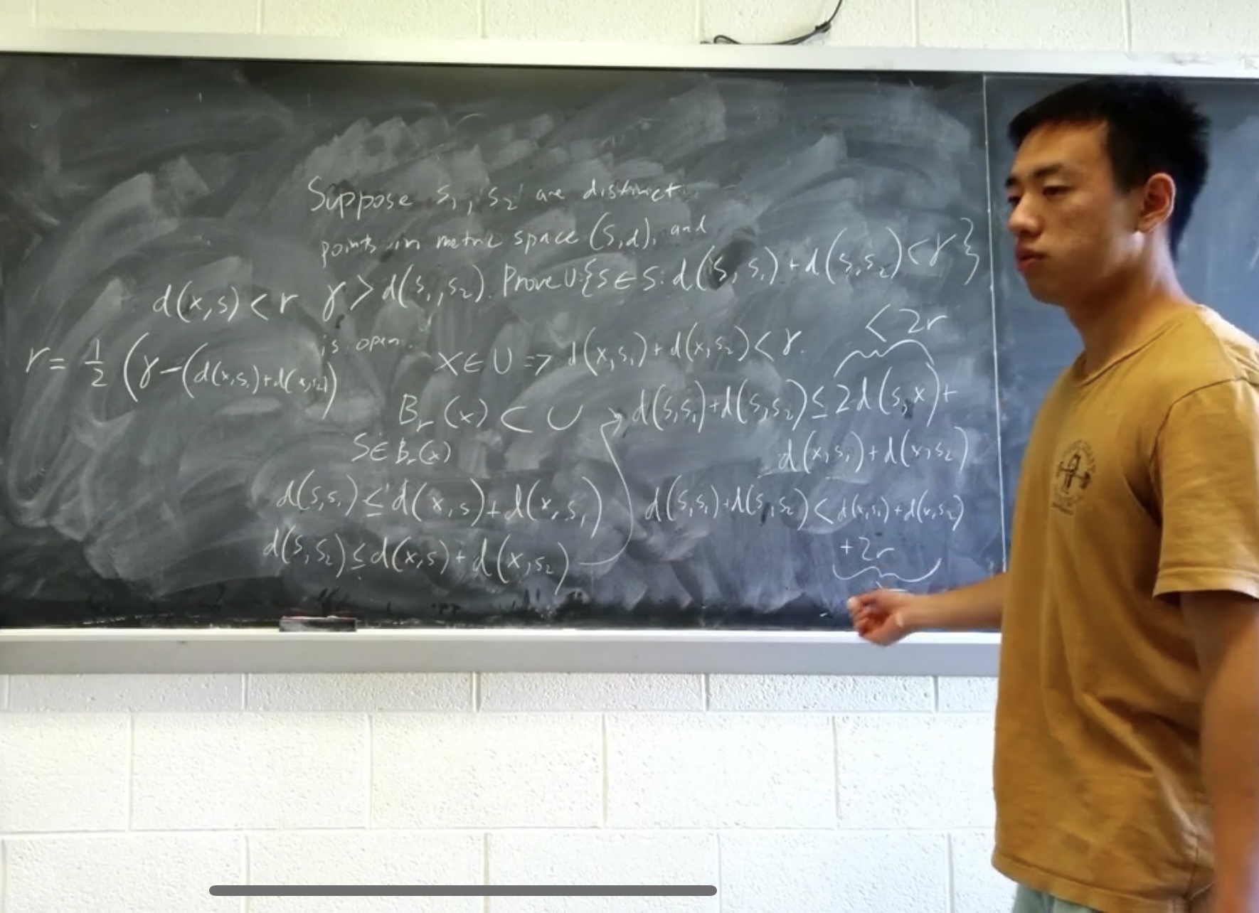 Jerich Lee presenting a real analysis proof at a chalkboard